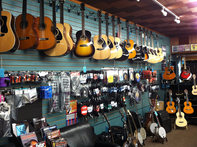 Acoustic guitars, electric guitars, banjos, guitar straps, guitar strings, and guitar cases at The Symphony Music Shop in North Dartmouth, MA Acoustic guitars, electric guitars, banjos, guitar straps, guitar strings, and guitar cases at The Symphony Music Shop in North Dartmouth, MA